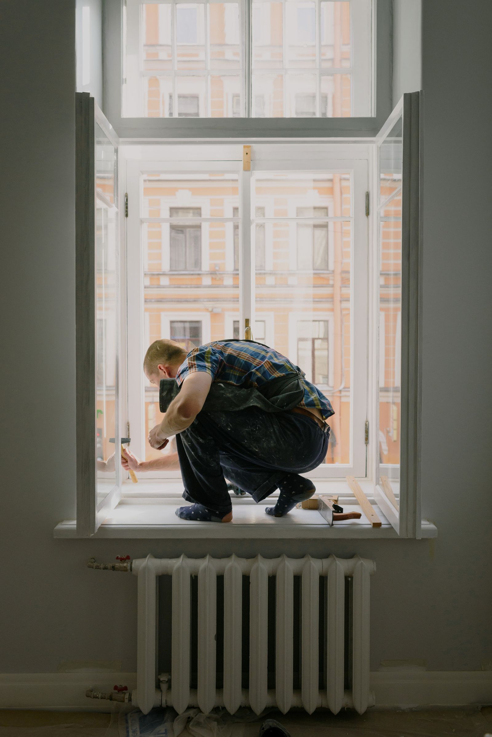 A tradesperson repairing a window